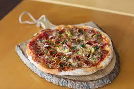 roman gladiator pizza with pepperoni sausage mortadella mozzarella pecorino pepperoncini and tomato flavorful pasta wood oven pizza food