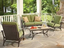 Not only does a covered seating area protect you from the harsh sunlight, but it is instantly more cozy and intimate. Covered Outdoor Seating Area With Green Sofa And Chairs Hgtv