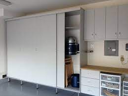 Garage Cabinets Are Made With Sliding Doors Which Saves Space Is Practicle And Leaves More Room For T Garage Cabinets Garage Interior Garage Storage Shelves