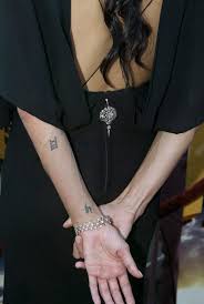 This big cross tattoo along with a latin phrase was done to cover the marks of previously removed small dragon tattoo. Angelina Jolie Tattoos From Billy Bob To Brad Pitt S Spiritually Binding Thai Inkings Drawn By Ex Monk Ajarn Noo Kanpai