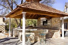 A bar behind the grill, a tv, an extended outdoor living space with heaters and loads of. Outdoor Kitchen Under Covered Structure On Patio Outdoor Kitchen Design Small Outdoor Kitchens Rustic Outdoor Kitchens