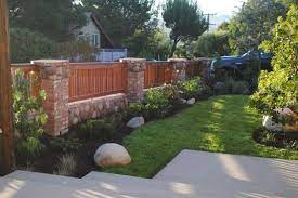 Old world brick mixed with bricks and stone, gives a rustic yet charming scenery. 13 Brick Fence And Column Designs A Quick Planning Guidefacebookgoogle Pinteresttumblrtwitteryoutube Backyard Fences Front Yard Fence Brick Fence