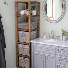 A curved built in linen cabinet is fitted with glass front cabinets flanked by white drawers adorned with polished nickel pulls and white overhead cabinets. Diy Linen Tower Free Plans Handmade Weekly