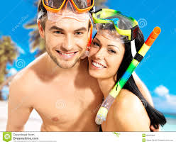 Portrait of happy fun beautiful couple at tropical beach with swimming mask on face. - fun-beautiful-couple-tropical-beach-swimming-mask-29525235
