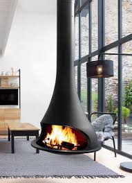 There's something romantic about being snowed in with a good book, a glass of wine, a loved one, and a roaring fire. Jc Bordelet Suspended Fireplace Wall Fireplace Modern Stoves
