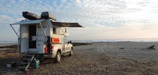 This camper comes with air conditioning, a microwave, leatherette seating material, solid sapele table, raised chrome graphics, and dual 100 watt solar panels. Living In A Truck Camper Buying Living And Traveling