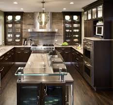 Espresso kitchen cabinets are a beautiful, elegant deep dark brown that pairs well with classic whites and creams, cool blues and greens, and bold contemporary reds, silvers, and blacks. Contemporary Kitchen Design The Power Of Functionality Dark Brown Color Desig Contemporary Kitchen Interior Contemporary Kitchen Contemporary Kitchen Design