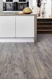 In A Gorgeous Grey Shade And With A Smoked Oak Look Series Woods Professional 12mm Laminate Flooring Lazio Laminate Flooring In Kitchen Grey Flooring Flooring