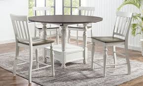 The extension leaf is stored within and can be accessed by both sides of the table top being pulled apart. Joanna Farmhouse Round Counter Height 5 Piece Dining Set The Dump Luxe Furniture Outlet