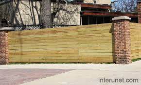 Angi.com has been visited by 100k+ users in the past month Fence With Brick Pillars And Horizontal Wood Boards Brick Pillars Backyard Fences Front Garden Design