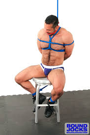 Muscular hunk tied up & cums