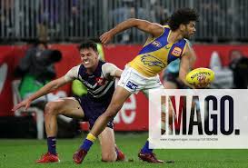 AFL DOCKERS EAGLES, Sam Petrevski-Seton of the Eagles is tackled by Heath  Chapman of the