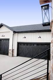 A glass front door with glass sidelights let guests see the breathtaking lake view even before stepping inside. Black Modern Farmhouse Garage Doors Novocom Top