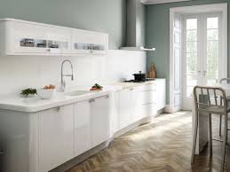 A small kitchen decorated with a black and white coral reef wall art mounted above the white cabinetry and fridge. Kitchen Ideas White Kitchen Ideas Uk