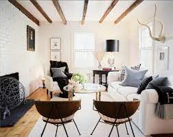 A patterned rug and pillows add dimension to the room, while black interspersed with neat white lines makes for a beautiful room. Living Room Inspiration How To Style A White Sofa