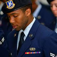 Engineman 1st Class Brandon Lovell is fitted for a combination cover by his  wife after being announced the 2017 Navy Reserve Sailor of the Year during  a ceremony at the U.S. Navy