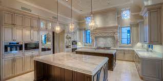 Contemporary cabinetry with stainless fixtures against dark wood make up the design of this luxury kitchen. Kitchen Islands Two Is Better Than One Fratantoni Luxury Estates