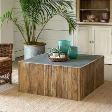 The pillar coffee tables are featured in a tall and a low version, made of plated metal in tree colours; Aged Zinc Coffee Table Iron Accents