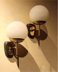 Wall sconces, on the other hand, can actually create space in a house for other furnishings or walkways. Stilnovo Style Italian Glass Globe And Gilt Brass One Light Wall Sconces 1950s