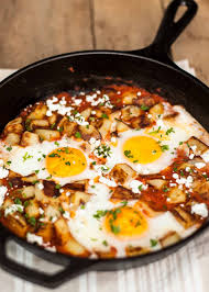 Why Not Serve Eggs For Dinner Fried Potatoes And Eggs Baked In Spicy Tomato Sauce And Topped With Some Goat Cheese Recipes Egg Free Recipes Breakfast Recipes