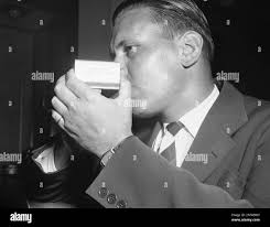 Douglas Cornell, Associated Press reporter, lights a cigarette, August 3,  1941. The match box was taken from President Franklin Roosevelt's desk  during a press conference at the White House. The lettering on