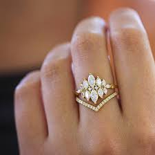 To break up really long fingers, consider an engagement ring with a large center stone or multiple stones to widen the hand a little. Unusual Engagement Ring Set With Marquise Diamonds Artemer