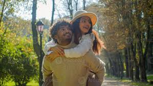 Happy family smiling multiracial couple Hispanic girlfriend woman female  piggyback ride point finger Indian man boyfriend male in love touching  hugging speak talk walking in park date nature outdoors 51021192 Stock Photo