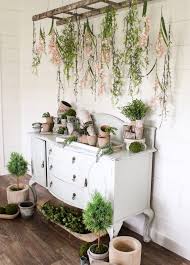 A reclaimed ladder hanging over a bathtub makes a memorable plant display. Hanging Flowers And Plants With Vintage Ladder Tutorial Cotton Stem