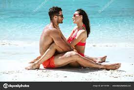 Romantic style portrait of a couple relaxing on a beach Stock Photo by  ©konradbak 281151764