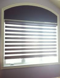 Window coverings are considered any type of materials used to cover a window to manage sunlight, privacy, additional weatherproofing or for purely decorative purposes. Room Darkening Solution For Bedroom Including Covering The Extended Eyebrow Arch Window Arched Window Treatments Arched Window Coverings Window Treatments