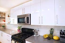 At first glance, the bright and shiny white gloss will give doors on these cabinets swing upward rather than left or right; Contemporary White High Gloss Foil Kitchen Cabinets Contemporary Kitchen Austin By Ub Kitchens Kitchen Design And Cabinets Houzz