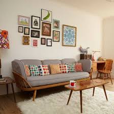 The symmetrical living room features matching floral printed and red striped chairs along with taupe facing sofas over a vintage rug. Retro Living Room With Pretty Prints Living Room Decorating Ideal Home Colourful Living Room Retro Living Rooms Mid Century Living Room