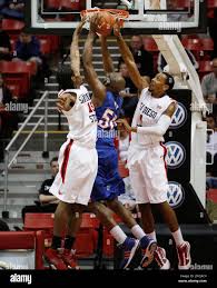 San Diego State's Kawhi Leonard, left, and Malcolm Thomas, right, block a  shot by Pomona-Pitzer's Donald Okpalugo, center, during the second half of  an NCAA college basketball game Thursday, Dec. 31, 2009,