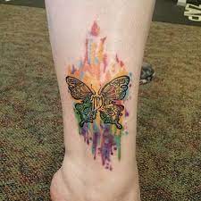 This Rainbow Watercolor Tattoo Is Amazing The Details In The Butterfly Look Incredible With The Zodia Butterfly Tattoo Designs Butterfly Tattoo Tattoo Designs
