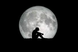 Desperate and lonely man in the background of the moon at night. Desperate, heartbreaking, and lonely concepts 9274010 Stock Photo at Vecteezy