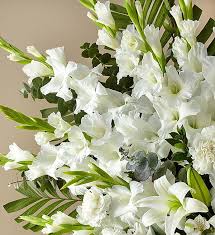 This romantic bouquet is sure to do just that, boasting roses, asiatic lilies and monte casino blooms in a clear gathering vase. White Rose And Lily Standing Spray 1800flowers Com 147293