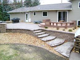 There are different ways to create a pea gravel patio. Raised Paver Patio With Retaining Walls Stairs Deck And Seating Wall Oasis Landscapes West Fargo Nd