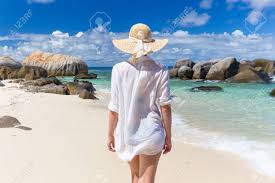 Woman Wearing White Loose Tunic Over Bikini And Beach Hat On Mahe Island,  Seychelles. Summer Vacations On Picture Perfect Tropical Beach Concept.  Stock Photo, Picture And Royalty Free Image. Image 65018160.
