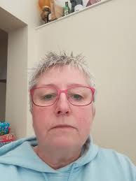 Grandma gives granddog a spa day with bathing suit and nail polish