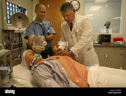 Oct 19, 2006; Boca Raton, FL, USA; Doctor Lawrence Brickman completes a  procedure as instructor Lew Steinberg of North Palm Beach Fire-Rescue  assists. Doctor Mark Goldstein (right rear) can control the life