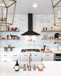 The gold hardware accents in this kitchen design are intentionally placed to perfectly complement the bright white finishes. Black And Rose Gold Kitchens Novocom Top