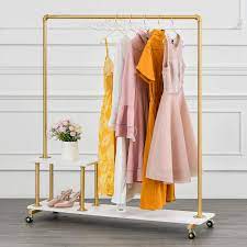 This rack features push button arms that make it easy to adjust in 3 increments from 48 to 72 tall. Amazon Com Bosuru Metal Rolling Clothing Rack On Wheels Industrial Pipe Clothes Rack With Wood Shelves Heavy Duty Modern Garment Rack For Laundry Room Retail Store Gold 51 H Home Kitchen