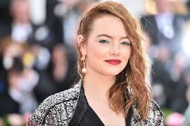 The image sees emma stone rocking the full de vil look, with several dalmatians on leashes in front of her. The First Look At Emma Stone As Cruella De Vil Is Here Glamour