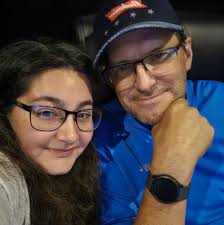 Who can recommend a photographer for high school senior photos at the beach  in July?