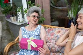 Look online for photo printing services like shutterfly that can design and print memory books. 70 Years Old Woman Holding A Gift Box Photographed By Her Friend By Beatrix Boros Senior Photograph