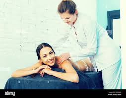 Portrait of young czech woman enjoying relaxing massage by professional  masseur Stock Photo - Alamy