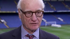 Chelsea chairman Bruce Buck says Roman Abramovich remains committed to the  club, despite not attending games at Stamford Bridge