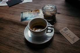 Coaster 720218 cuppuccino glass top coffee table with stool. Cup Of Coffee On A Table Free Photo On Barnimages