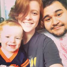 Mechanic holding drums with apprentice