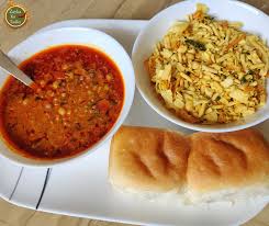 Maharastrian misal pav is a spicy moong sprouts curry topped with onions, sev, lemon and served with salt to taste. Misal Pav Mumbai Famous Misal Pav Zayka Ka Tadka